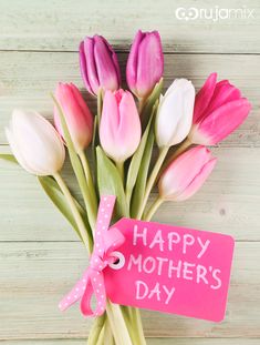 a bouquet of tulips with a pink tag that says happy mother's day