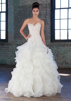 a woman in a white wedding dress posing for the camera