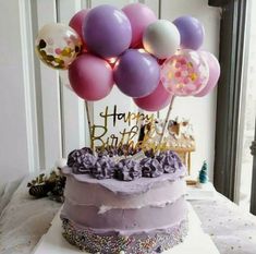 a birthday cake with lots of balloons on top