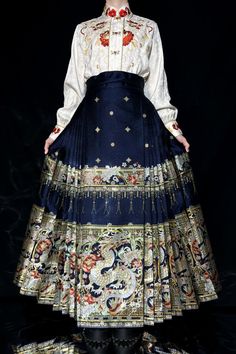 A special construction style of traditional Mamian Qun 马面裙 (horse face skirts), with 8 pairs of pleats on each side to create the most dramatic and flowy skirt possible. A popular skirt from the Ming Dynasty, this A-line skirt is not only comfortable, but flattering on every body type! The brocade features a fierce twisted dragon, peonies, cherry blossoms, camellias, stars, lanterns, and more. All symbols of peace, prosperity, and protection. Made from various colored threads and golden accents Traditional Red Flared Maxi Skirt, Traditional Red Flowy Maxi Skirt, Traditional Flowy Red Maxi Skirt, Traditional Red Lined Maxi Skirt, Traditional Blue Flowy Skirt, Traditional Red Flowy Skirt, Traditional Flowy Blue Skirt, Traditional Long Pleated Skirt, Traditional Full Gathered Skirt