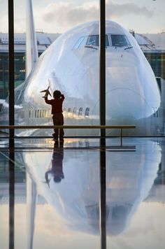 a small child standing in front of an airplane