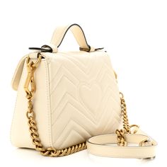 This is an authentic GUCCI Calfskin Matelasse Mini GG Marmont Top Handle Shoulder Bag in White. This shoulder bag is crafted of smooth & supple calfskin leather in white. This bag features a leather handle, and a long aged gold chain shoulder strap with a leather shoulder pad. The front crossover flap opens to a beige microfiber interior with a patch pocket. Gucci Marmont Bag, Soho Disco Bag, Gucci Crossbody Bag, Gucci Crossbody, Small Messenger Bag, Vintage Monogram, Gucci Shoulder Bag, Gg Marmont, Black Phone Case