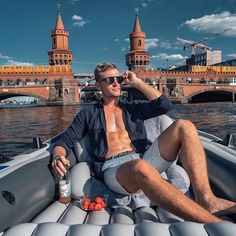 a man sitting on top of a boat in the water