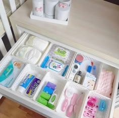 the drawer is filled with personal care items and has been placed neatly on the table