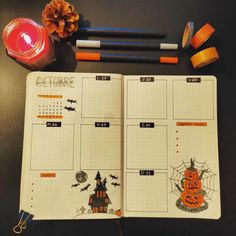 an open planner with halloween decorations on it