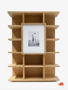 a wooden book shelf with a photo on it