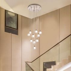 a chandelier hanging from the side of a staircase