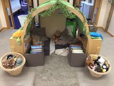 a child's play tent with stuffed animals and toys in baskets on the floor