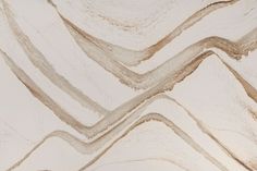 an abstract pattern made up of white and brown lines on a wallpapered surface