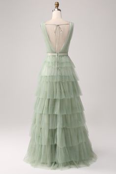 a green dress on a mannequin with a backless top and tiered tulle