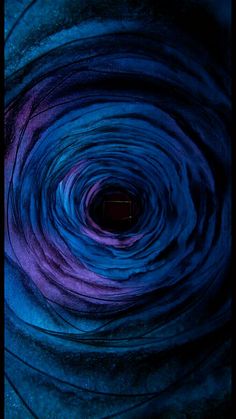 a blue and purple swirl is shown in this image