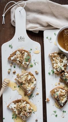 two white plates topped with toast covered in cheese