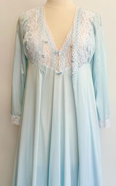 Vintage 70's pale blue peignoir & nightgown set with white lace trim 100% nylon Peignoir marked size XS and seem to fit a modern XXS.  Photographed on a size 2/4 dress form without an inch to spare at the bustline.  Please use measurements to ensure proper sizing. Peignoir measurements (buttoned & laying flat): Shoulder seam-to-shoulder seam: 12-1/4" Pit-to-pit: 15" Top of shoulder-to-hem: 54-1/2" Pit-to-cuff: 14-1/2" Nightgown measurements (laying flat): Pit-to-pit: 15" Top of shoulder to hem: 53-1/2" Good vintage condition with minor wear.  There is a small gap between the chest and lace trim which you can see in the last photo A NOTE ABOUT MY CLOTHING LISTINGS: I'm very picky when it comes to cut and style so you can rest assured my vintage garments will be WEARABLE mixed in with your m Vintage Light Blue Sleepwear With Lace Trim, Light Blue Lace Trim Nightgown For Bedtime, Light Blue Lace Trim Nightgown For Home, Light Blue Lace Trim Nightgown, Fitted Light Blue Sleepwear With Lace Trim, Light Blue Fitted Sleepwear With Lace Trim, Glorify God, Nightgown Sets, Peignoir Sets