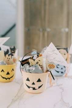 a basket filled with halloween treats sitting on top of a table next to other items