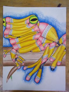 a drawing of a yellow frog sitting on top of a wooden table