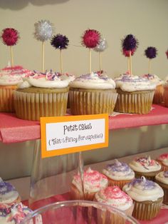 cupcakes are on display at a bakery