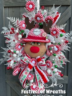 a christmas wreath with a reindeer head and candy canes