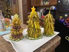 three christmas trees made out of bananas on a kitchen counter