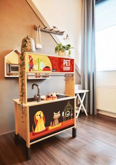 a wooden toy kitchen with an animal theme