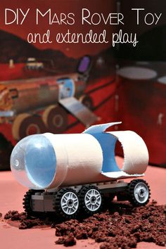 a toy truck is made out of clay and plastic bottles, with dirt on the ground next to it