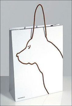 a white shopping bag with a dog's head drawn on it