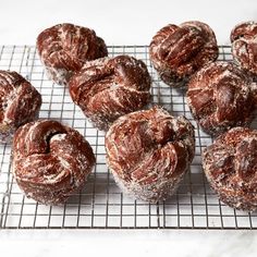 several pastries on a cooling rack with powdered sugar