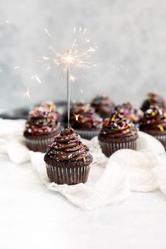 chocolate cupcakes with sprinkles and a sparkler