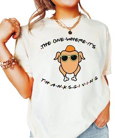 Get into the Thanksgiving spirit with this fun and quirky t-shirt! Featuring a cool turkey wearing sunglasses and the playful phrase 'The One Where It's Thanksgiving,' this tee is perfect for adding a humorous touch to your holiday wardrobe. Designed for women, it's a great choice for Thanksgiving gatherings, fall outings, or even Friendsgiving celebrations! Key Features: -Funny turkey graphic with sunglasses and playful text -Perfect for Thanksgiving, fall, and Friendsgiving -Soft and comfortable fabric for all-day wear -Available in a range of sizes for women -Great for casual fall outfits, Thanksgiving dinner, or festive photos Care Instructions: Machine wash cold, tumble dry low, do not iron directly on the graphic Designed and printed in the USA - Olive Loves Apple, based in Mesa, AZ Funny Thanksgiving Shirts Shirts By Sarah, Friends Tv Show Thanksgiving Shirt, Friends Tv Show Thanksgiving Shirts, Fall Outfits Thanksgiving, Fall Outings, Quirky T Shirts, Funny Thanksgiving Shirts, Funny Turkey, Photo Care