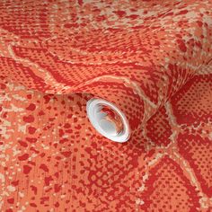 an orange and white pattern on fabric