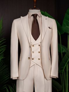 Color: beige Material: 73% polyester, 23% viscose, 4% elastane Suit includes blazer, waistcoat, & trousers Single-breasted suit (2-button blazer) Lapel type: peak lapels Jacket interior lining option: fully-lined Jacket vent: double vent Fitting: modern-fit Care instructions: dry clean only Machine washable: no 3 Piece Suit Men Classy, 3 Piece Suit Men, Blazer Waistcoat, Bow Tie Suit, Modern Fit Suit, Suit Styles, Suit Stores, Slim Fit Suit Men, Beige Suits