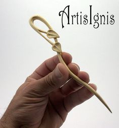 a hand is holding an object with the word artisans written in front of it