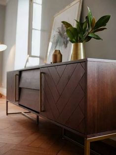 a sideboard with a plant on top of it