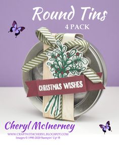 the round tins are decorated with christmas wishes