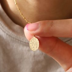 This dainty gold necklace is set with a miraculous coin pendant featuring Virgin Mary and a chain necklace. Made with high quality 14K gold filled materials and perfect for everyday wear - we love wearing it as a protection necklace. 14K gold filled pendant 14K gold filled necklace (Cable or Satellite) Pendant size: 9 x 13 mm, Thickness: 1.1 mm Comes with 2" extender Nickel-free Dainty Necklace With Miraculous Medal, Mary Necklace, Virgin Mary Necklace, Dainty Gold Necklace, Protection Necklace, Solid Gold Jewelry, Coin Pendant, Gold Filled Jewelry, Dainty Necklace