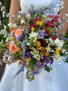 a bride holding a bouquet of flowers in her hands