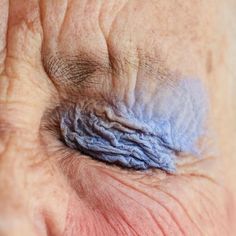 an older person's eye with wrinkles on the outside of its irise