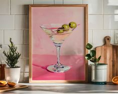 a painting of a martini glass with olives in it on a counter top next to an orange slice