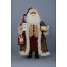 a santa clause figurine holding a cup and saucer with a sign in his hand