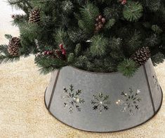 a potted christmas tree with pine cones and berries on the top is shown in this image