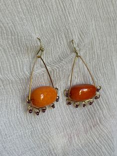 Handmade Bead and Wire Earrings Orange Stones, Purple Seeds Beads, and Wire Work - Etsy Handmade Amber Round Bead Earrings, Handmade Amber Beaded Round Earrings, Handmade Amber Earrings With Round Beads, Orange Czech Glass Dangle Earrings, Orange Teardrop Jewelry With Colorful Beads, Orange Czech Glass Jewelry With Ear Wire, Handmade Teardrop Orange Jewelry, Handmade Orange Teardrop Jewelry, Beaded Copper Teardrop Earrings