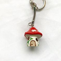 a mushroom keychain with a red hat on it's head is shown