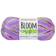 a ball of yarn that is purple and white with the words bloom on it in red,