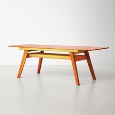 a wooden table sitting on top of a white floor