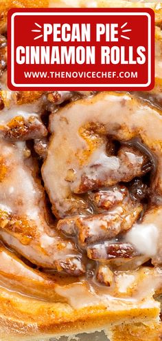 a cinnamon roll with icing sitting on top of a table next to a red sign that says pecan pie cinnamon rolls