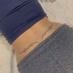 a woman with a tattoo on her lower back