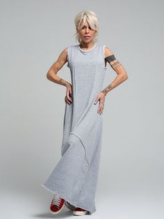 Our grey maxi dress is the epitome of laid-back chic, made from soft viscose that drapes beautifully for a comfortable yet stylish look. Its sleeveless design and subtle scoop neckline offer a casual elegance that's perfect for sunny days or layered under a jacket when the evening cools down. FEATURES:Sleeveless with a relaxed fit and a long, flowing silhouette. Ideal for leisurely weekend wear or as a base for accessorizing100% Handmade. SIZE & FIT: Fit: A relaxed fit with room to moveModel is wearing size Small or S/M View our SIZE CHART before ordering MATERIALS & CARE: Content: 65% Cotton, 35% Polyester Care: Machine wash on cold (30ºC) with a mild detergent. SHIPPING: Made to order, the processing time is 15 working days This item will be shipped via DHL Gray Long Summer Dress, Long Gray Summer Dress, Gray Lagenlook Summer Dress, Casual Gray Maxi Dress For Summer, Flowy Sleeveless Viscose Maxi Dress, Summer Longline Maxi Dress Loungewear, Summer Longline Maxi Dress For Loungewear, Casual Sleeveless Maxi Dress For Loungewear, Sleeveless Gray Maxi Dress For Spring