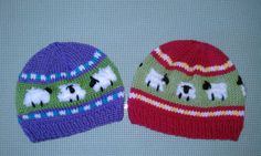 two knitted hats with sheep on them, one is green and the other is red