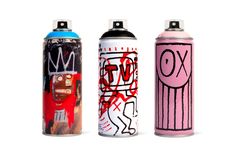 three spray cans with graffiti on them are lined up next to each other in different colors