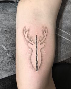 a black and white photo of a deer's head with a clock on it