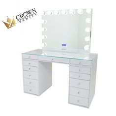 a white vanity with lighted mirror and drawers on it's sides, in front of a crown logo